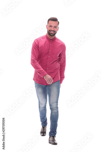 smiling young man in jeans stepping forward . isolated on white