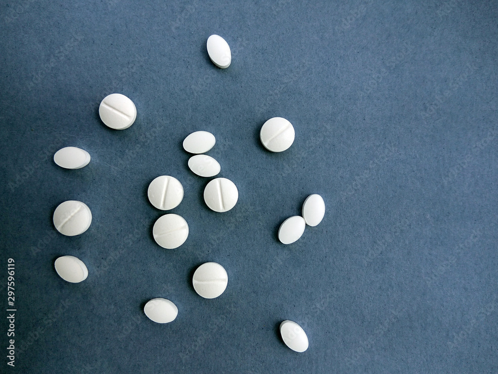 photo white pills on a blue background