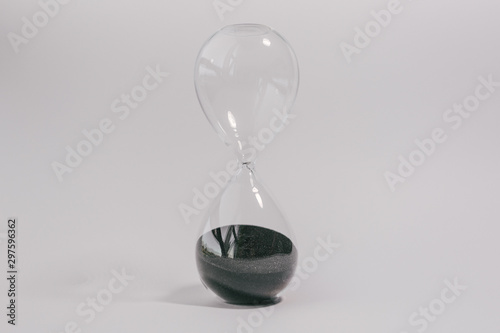  hourglass on a white background. black sand. glass clock. 