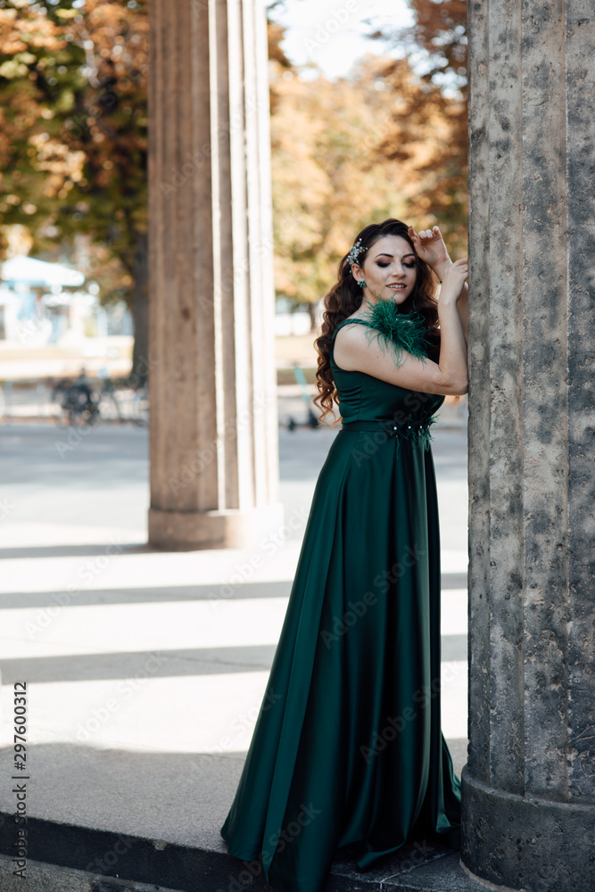 Beautiful girl with long wavy hair in green dress. Brunette with curly hairstyle posing. Beautiful woman with professional make up. Sexy girl posing. Female fashion. Beautiful girl with long wavy hair in green dress. Brunette with curly hairstyle posing. Beautiful woman with professional make up. Sexy girl posing. Female fashion.