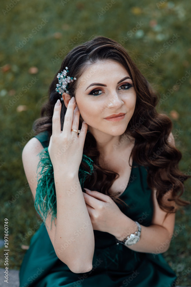 Close up fresh beauty portrait of cute amazing smiling girl, natural glow make up, green dress. Fashionable, trendy. Brunette with curly hair style posing. Beautiful woman with professional make up Close up fresh beauty portrait of cute amazing smiling girl, natural glow make up, green dress. Fashionable, trendy. Brunette with curly hair style posing. Beautiful woman with professional make up