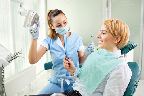Dentist and patient with mirror