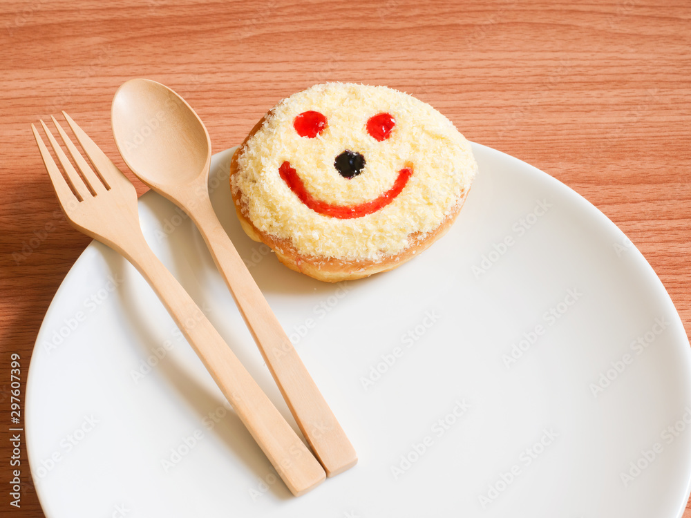 Smiley face, A smiley donut on a plate, white background Smiley face, A smiley donut on a plate, white background