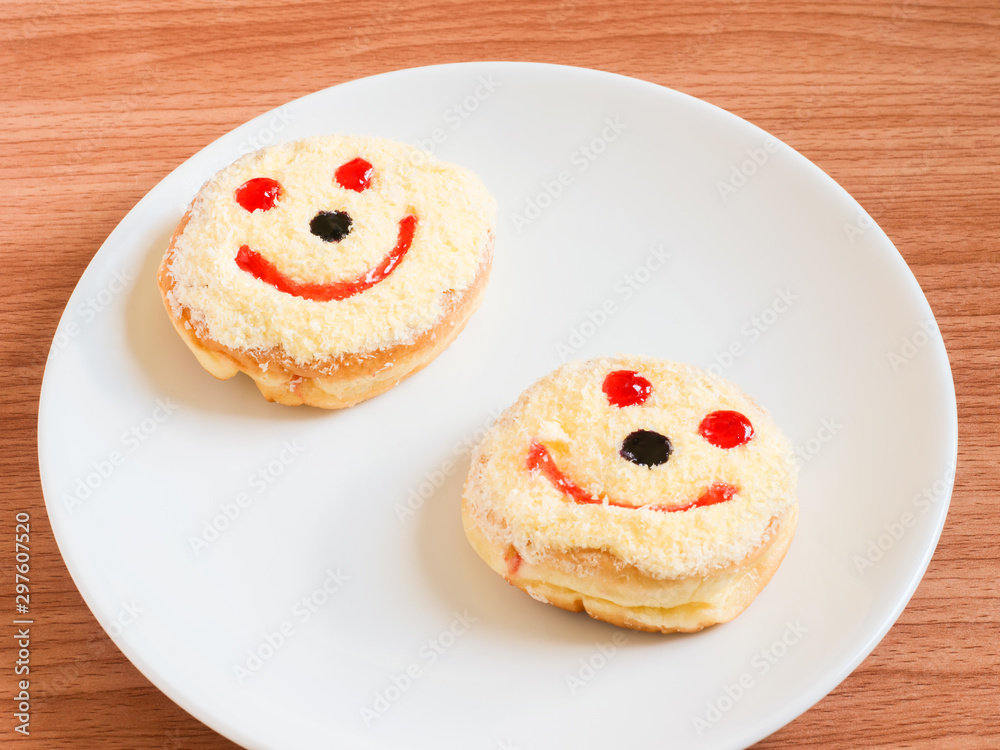 Smiley face, A smiley donut on a plate, white background Smiley face, A smiley donut on a plate, white background
