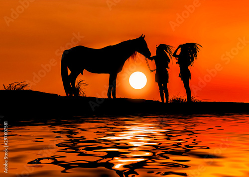 Image is silhouette. Women Sunset with Horse Bohemian hippie style and water reflection..