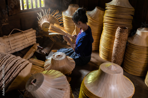 Young women are weaving in field handmade basket of Thailand.