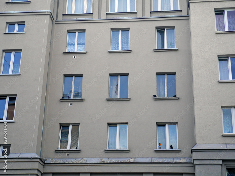 Fototapeta premium facade of building with windows and shutters