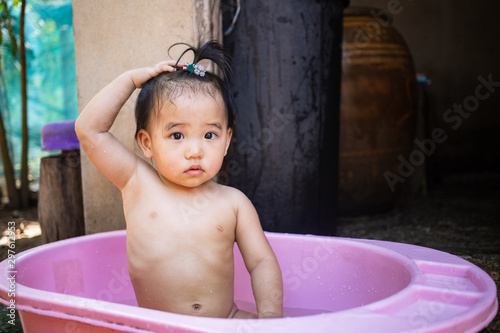 Принти на полотні Little kid enjoying to take a bath in bath tub outdoor
