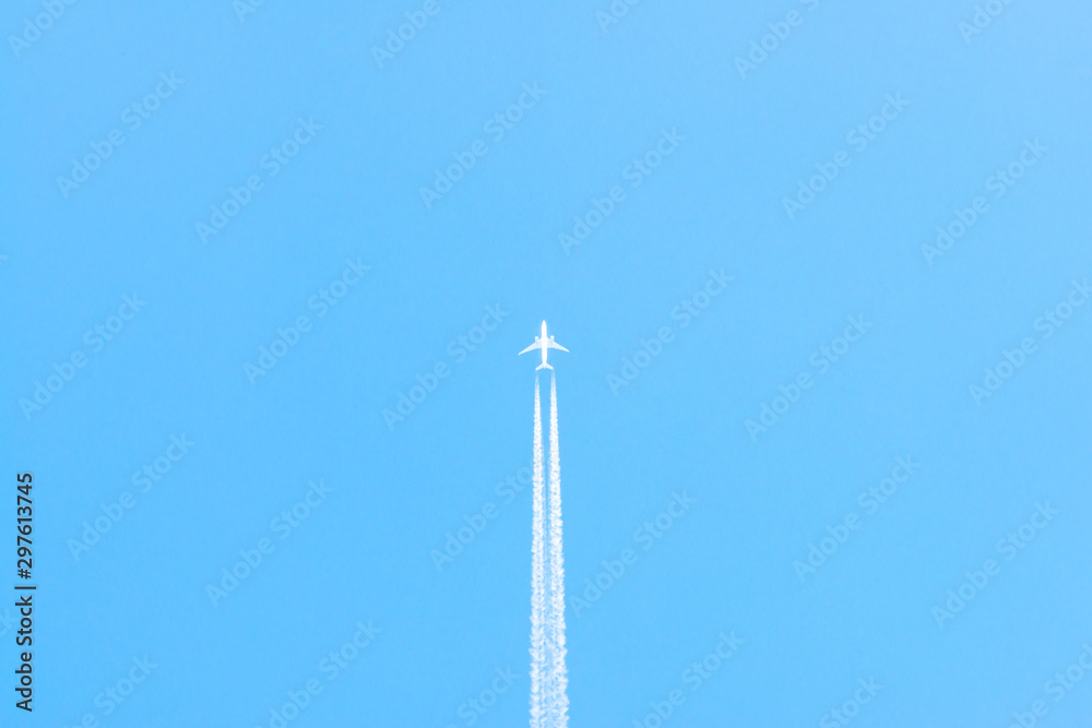 Airplane in a blue sky with clouds and condensation trails, Germany Airplane in a blue sky with clouds and condensation trails, Germany