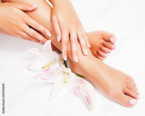 Fototapeta Naklejka Na Ścianę i Meble -  manicure pedicure with flower lily close up isolated on white perfect shape hands spa salon
