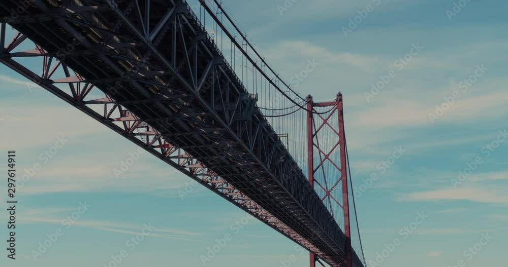 Aerial view. Under the bridge. Suspension bridge over Tagus river in Lisbon. 25th april bridge symbol of Portugal in sun shining. Aerial view. Under the bridge. Suspension bridge over Tagus river in Lisbon. 25th april bridge symbol of Portugal in sun shining.
