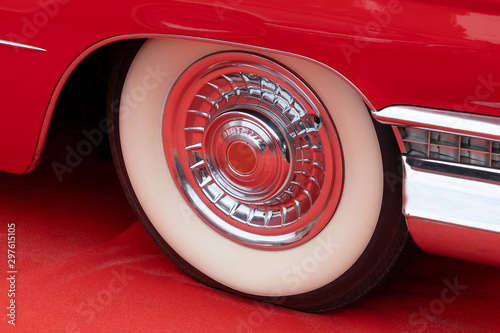 Red Retro Car Wheel on a Red Carpet © doomu