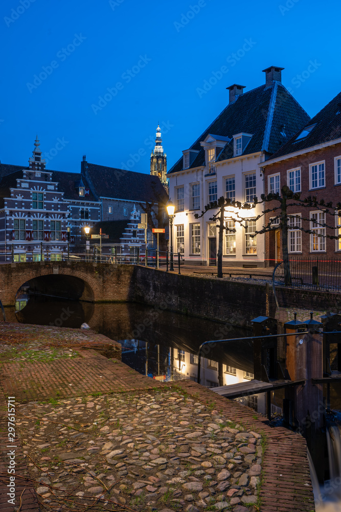 Dutch city of Amersfoort at night. canal behind Koppelpoort. street is called grote spui and kleine spui.