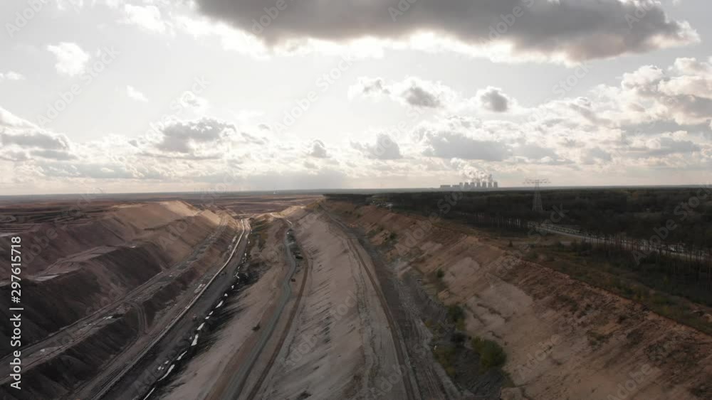 Slow aerial backwards shot of industy surface mine on cloudy day Slow aerial backwards shot of industy surface mine on cloudy day