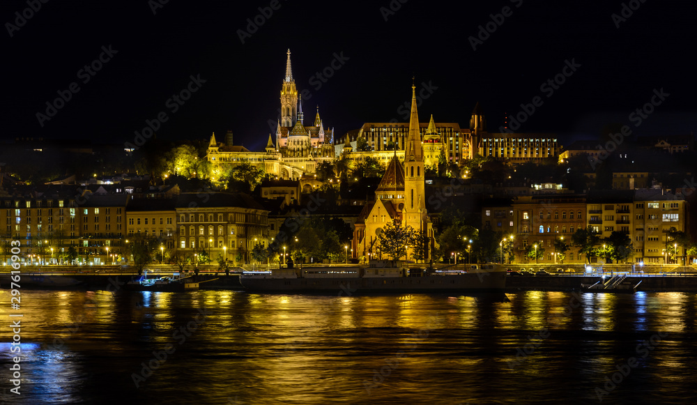 View of the evening Budapest from a pleasure boat. Buda in the evening illumination. Night city. Danube river at night. Walk and tour the Danube.
