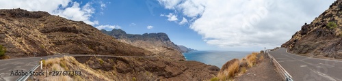 Panorama of costal road GC 200 on Gran Canaria winding its way along the west coast of the island. View of Tamadaba National Park an the Atlantic Ocean on a sunny day.