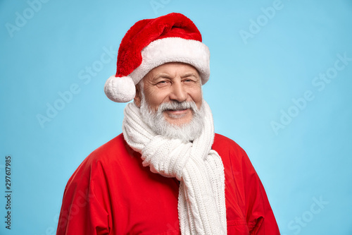 Happy Santa Claus in red hat isolated on blue background