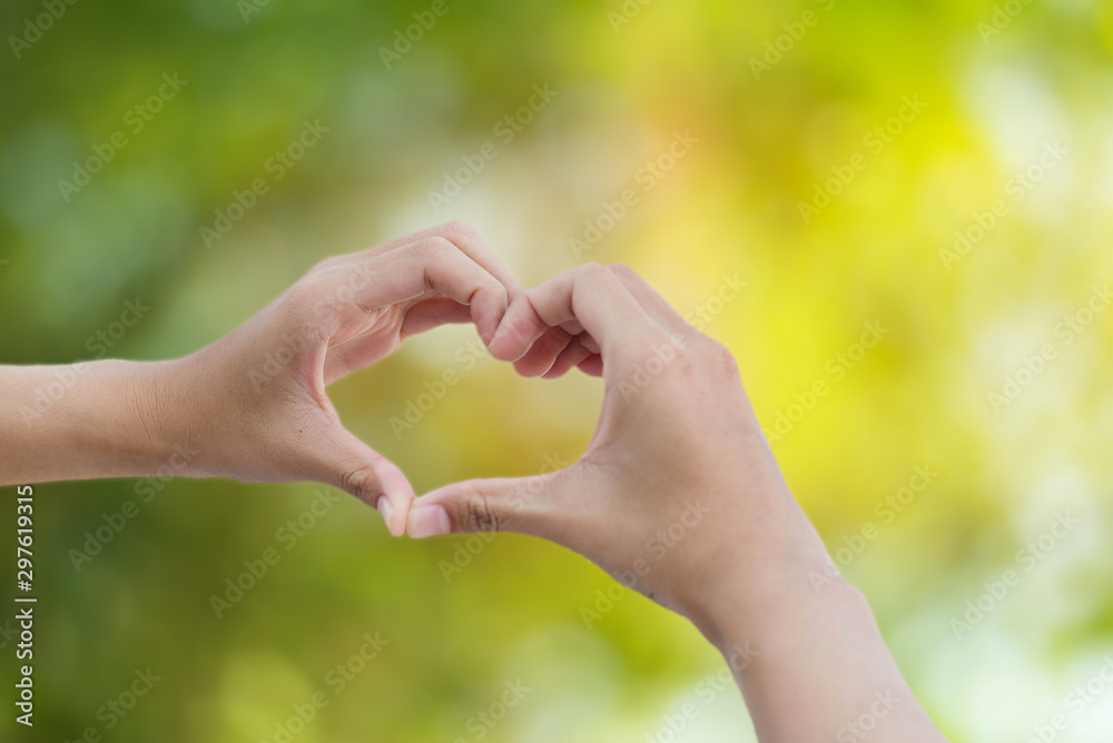 hand of love on green bokeh background