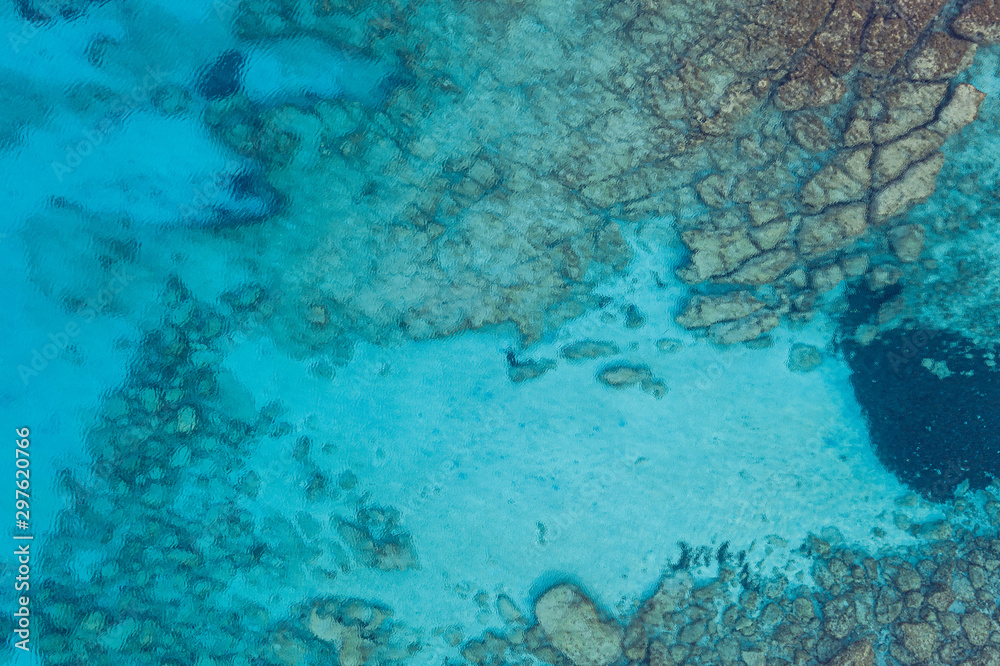 An aerial view of the beautiful Mediterranean sea, where you can se the rocky textured underwater corals and the clean turquoise water of blue lagoon Agia Napa An aerial view of the beautiful Mediterranean sea, where you can se the rocky textured underwater corals and the clean turquoise water of blue lagoon Agia Napa