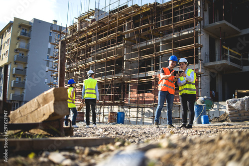 Fotobehang Group of construction workers on building site.Stock photo