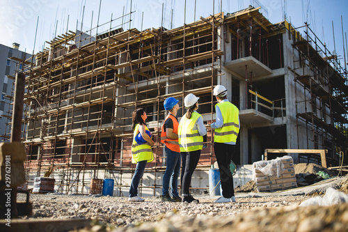 Group of construction workers on building site.Stock photo