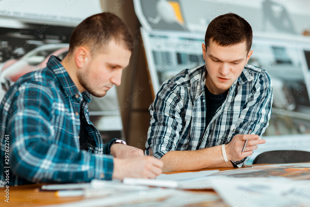 Two engineers debating their new project. Two engineers debating their new project.