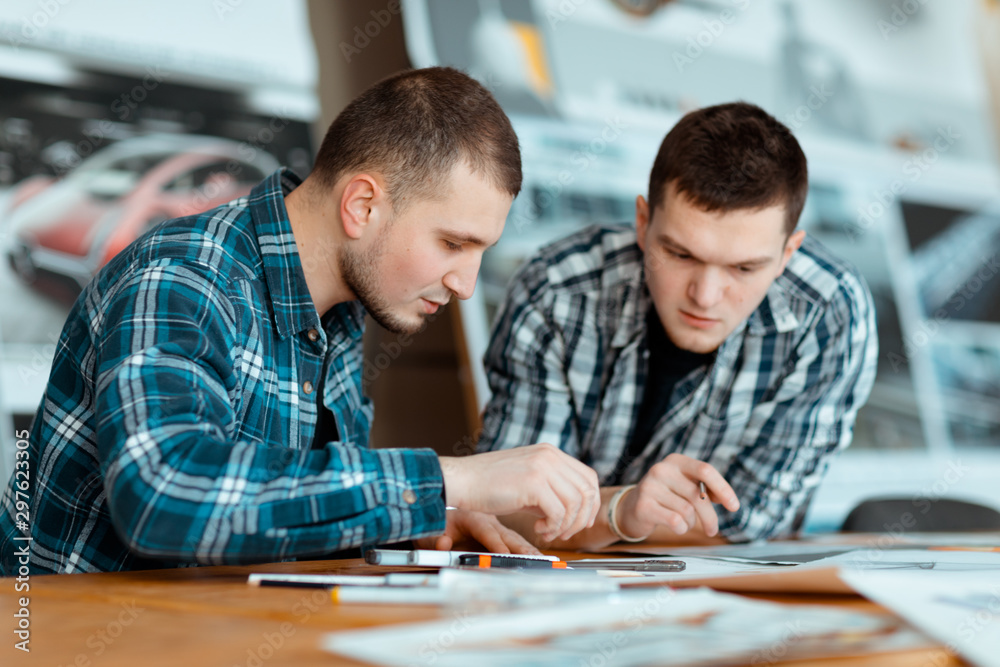 Two engineers thinking about a new design. Two engineers thinking about a new design.