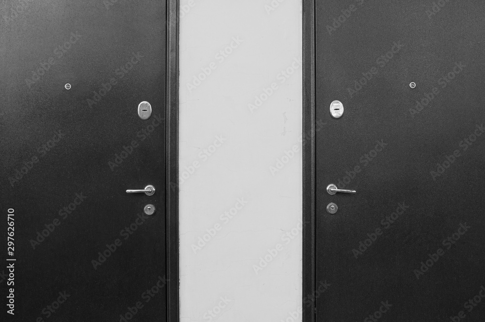 Two black and white symmetrical doors. Two black and white symmetrical doors.