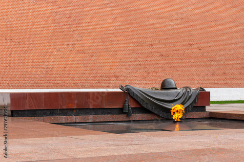 Moscow, Russia. Monument dedicated to the victory in World War II. The eternal flame breaks out of a metal star, a helmet and a banner of bronze. photo