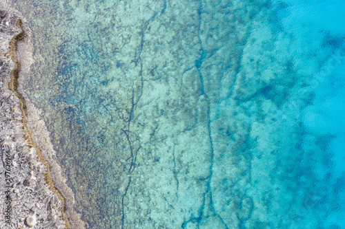 An aerial view of the beautiful Mediterranean sea, where you can se the rocky textured underwater corals and the clean turquoise water of blue lagoon Agia Napa