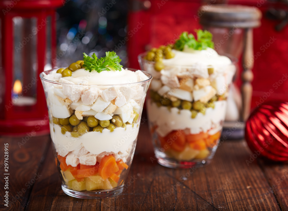 Layered Olivier salad with boiled vegetables in portion jar. Traditional Russian cuisine. Layered Olivier salad with boiled vegetables in portion jar. Traditional Russian cuisine.