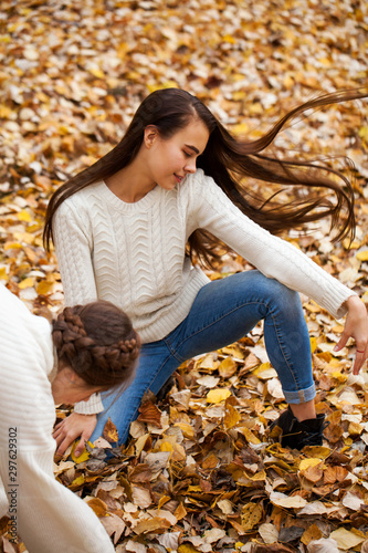 Young beautiful girl in blue jeans and gwhite sweater