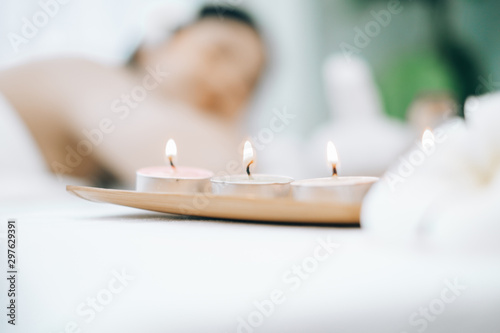 Beautiful young woman lying down on beds massage and spa at asian spa massage and beauty salon center, spa concept, massage concept