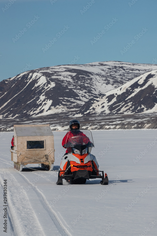 Tourists travelling by Qamutiik on the sea ice near Sirmilik National Park in Nunavut, Canada
