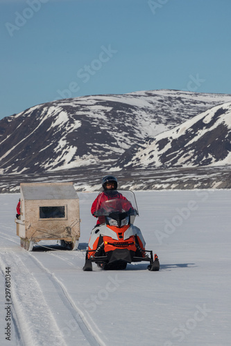 Obraz na płótnie Tourists travelling by Qamutiik on the sea ice near Sirmilik National Park in Nunavut, Canada w salonie