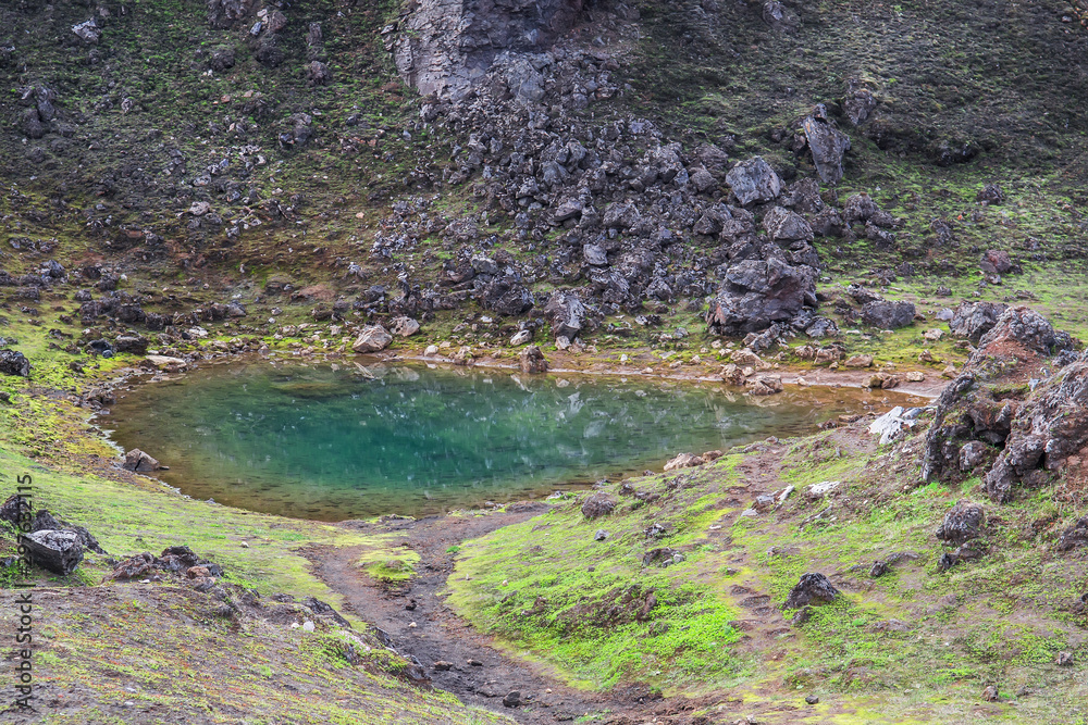 Obraz premium Emerald colored glacial lagoon in the midst of the surreal landscapes near Landmannalaugar along the Laugavegur hiking trail, Highlands of Iceland