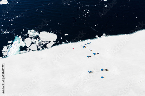 Aerial drone photo of tourists visit the floe edge near Sirmilik National Park in Nunavut, Canadaa