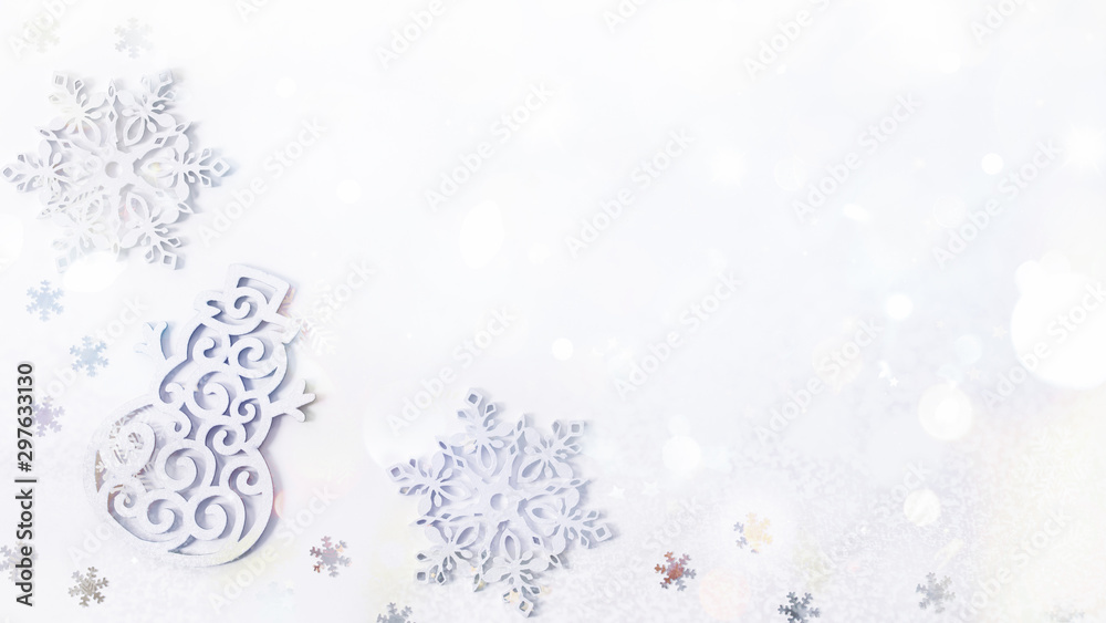Christmas background with white decorations in the form of a snowman and snowflakes top view. Christmas frame with festive decorations and shining sequins.