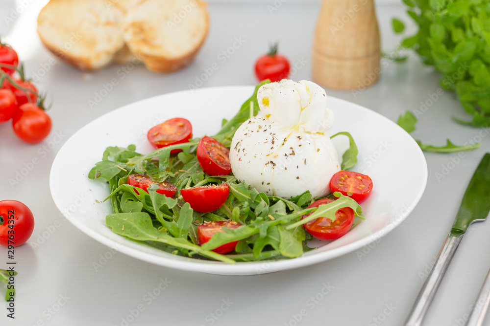 Fresh Salad with Italian burrata cheese, arugula, cherry tomatoes and olive oil. Healthy eating. Selective focus Fresh Salad with Italian burrata cheese, arugula, cherry tomatoes and olive oil. Healthy eating. Selective focus
