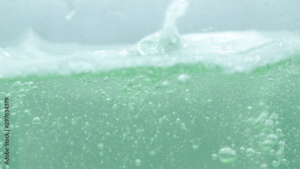 Water and soap, soap bubbles on the water surface, water waves, green water