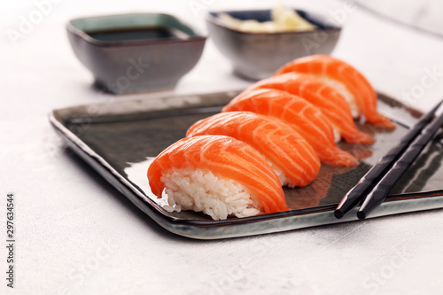 close up of sashimi sushi set with chopsticks and soy - sushi roll with salmon and sushi roll with smoked eel photo