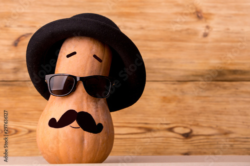 Cute man pumpkin face over rustic background photo