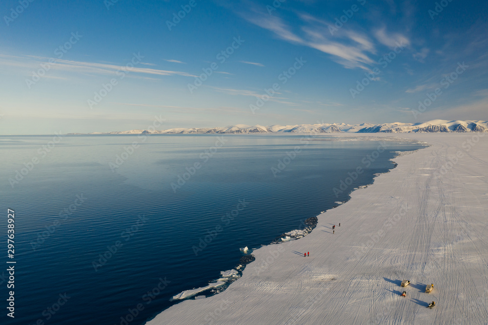 Obraz premium Aerial drone photo of tourists visit the floe edge near Sirmilik National Park in Nunavut, Canadaa