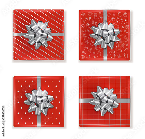 Top view of christmas red gift boxes with decorations and silver ribbon. Draw...
