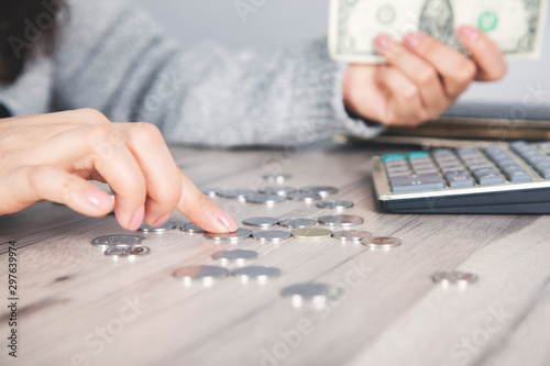 woman hand coins with calculator