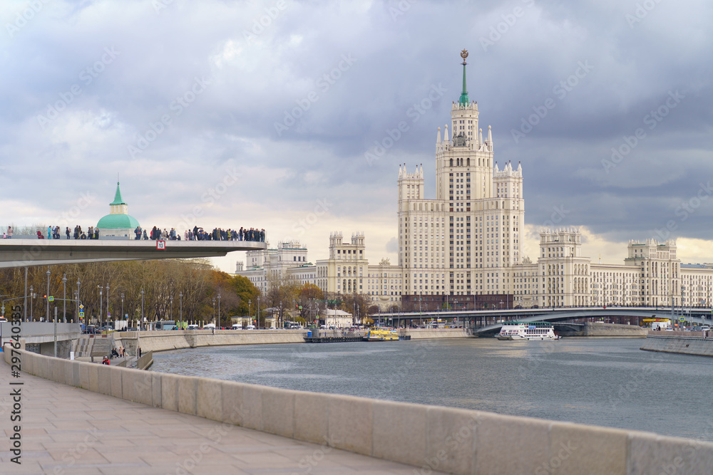 Photography of skyscraper on Kotelnicheskaya embankment and Observation Deck Zaryadye Park at autumn day. International touristic concepts.