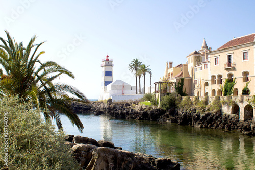 Beautiful view of the beach, lighthouse and villa on the sunny day. Cascais. Portugal.