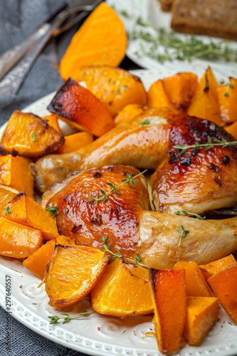 Homemade chicken thighs with pumpkin and oranges.