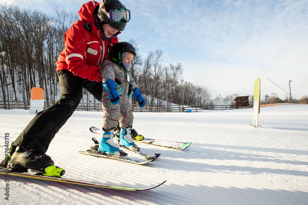 Young girl takes a skiing lesson