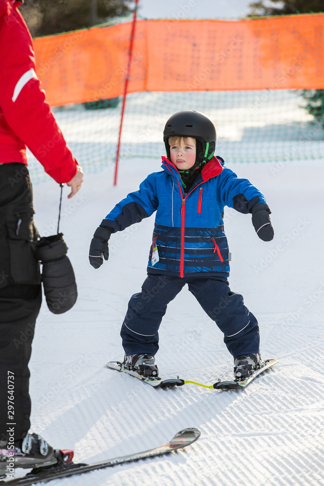 Young boy takes a skiing lesson